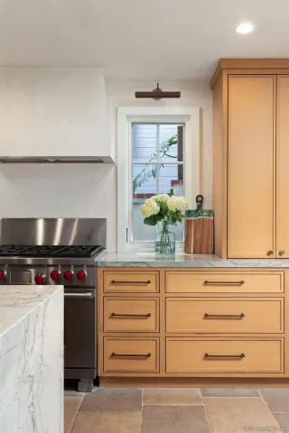 a kitchen with stainless steel appliances a stove and a window