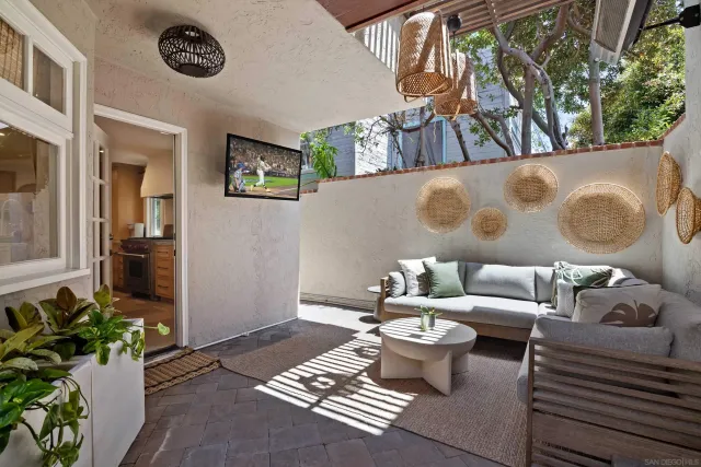 a living room with furniture and a potted plant