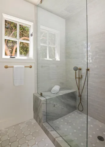 a bathroom with a toilet and a shower