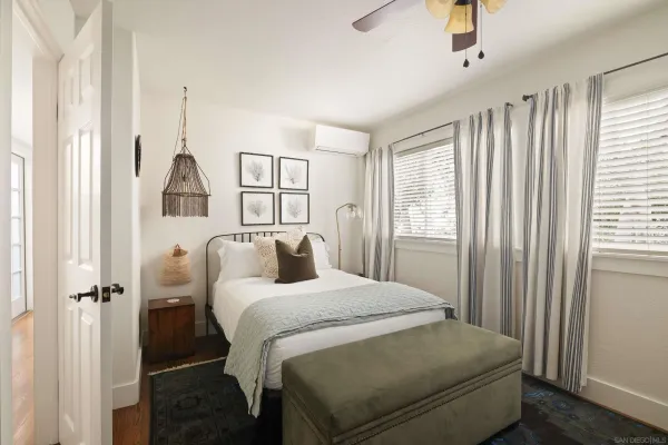 a bedroom with a bed and a window