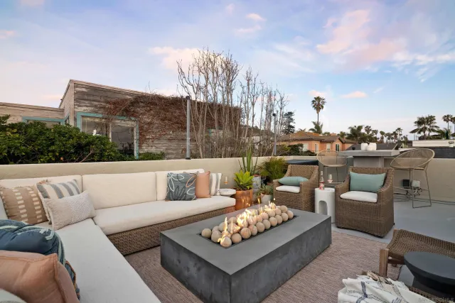 a view of a roof deck with couches and potted plants
