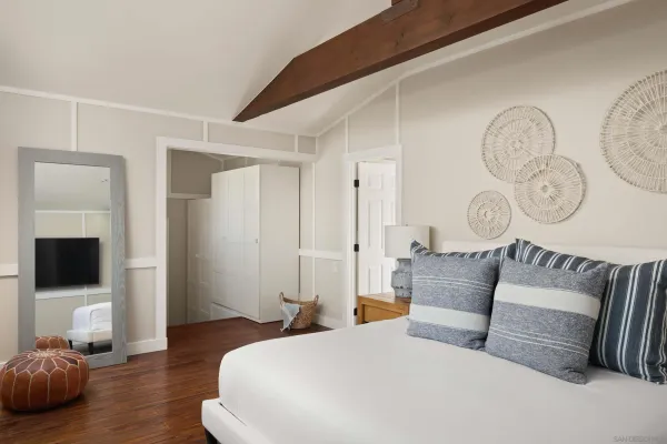 a living room with furniture a flat screen tv and a wall painting