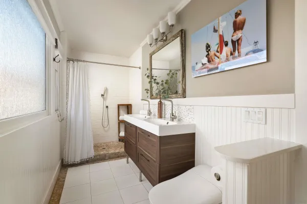a bathroom with a sink a mirror and a shower