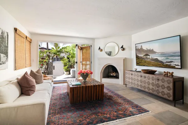 a living room with furniture a fireplace and a large window