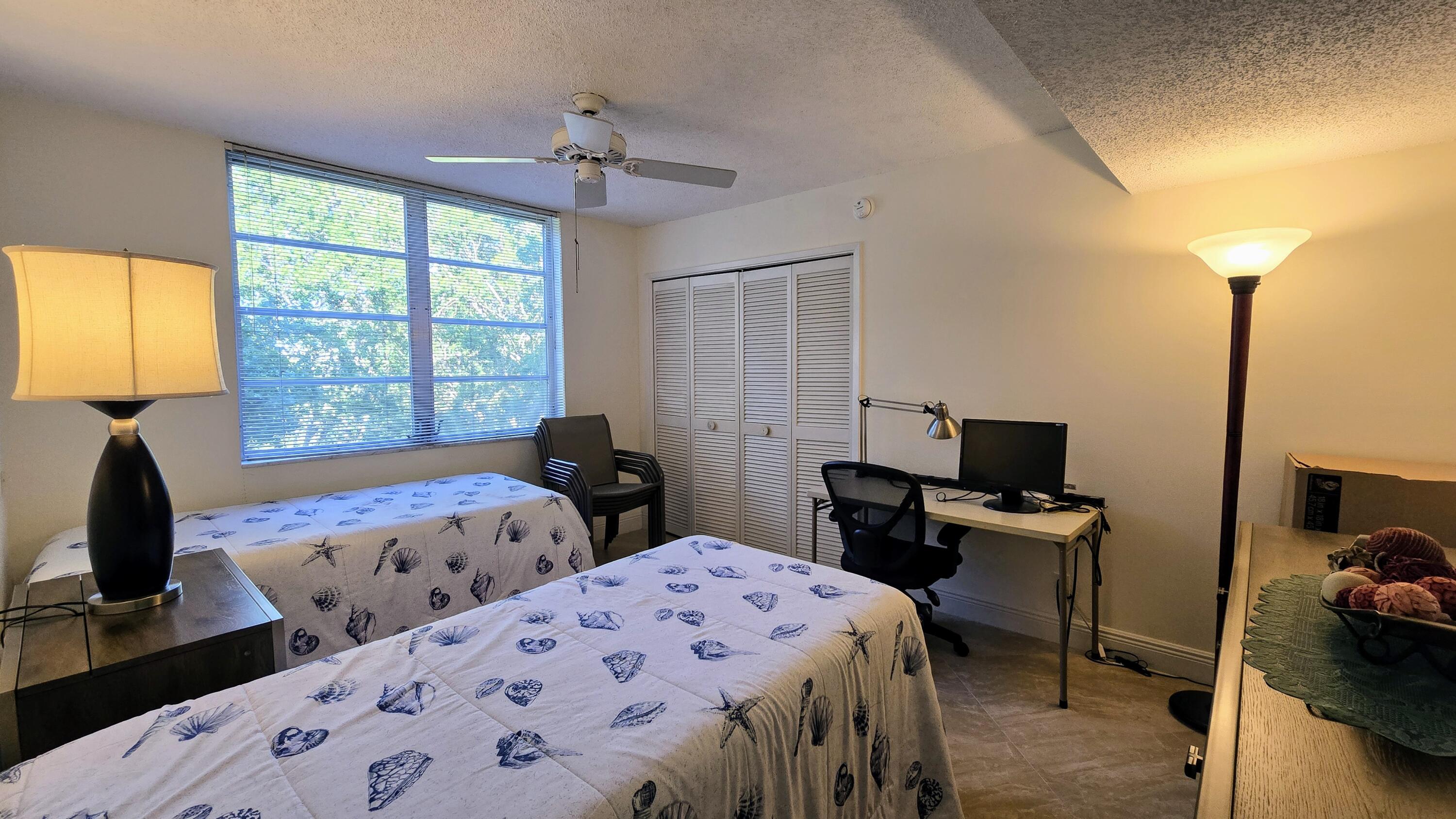 3100 North Course Lane, Unit 410 Pompano Beach, FL 33069 - Photo 17 of 23 a bedroom with two beds and a window