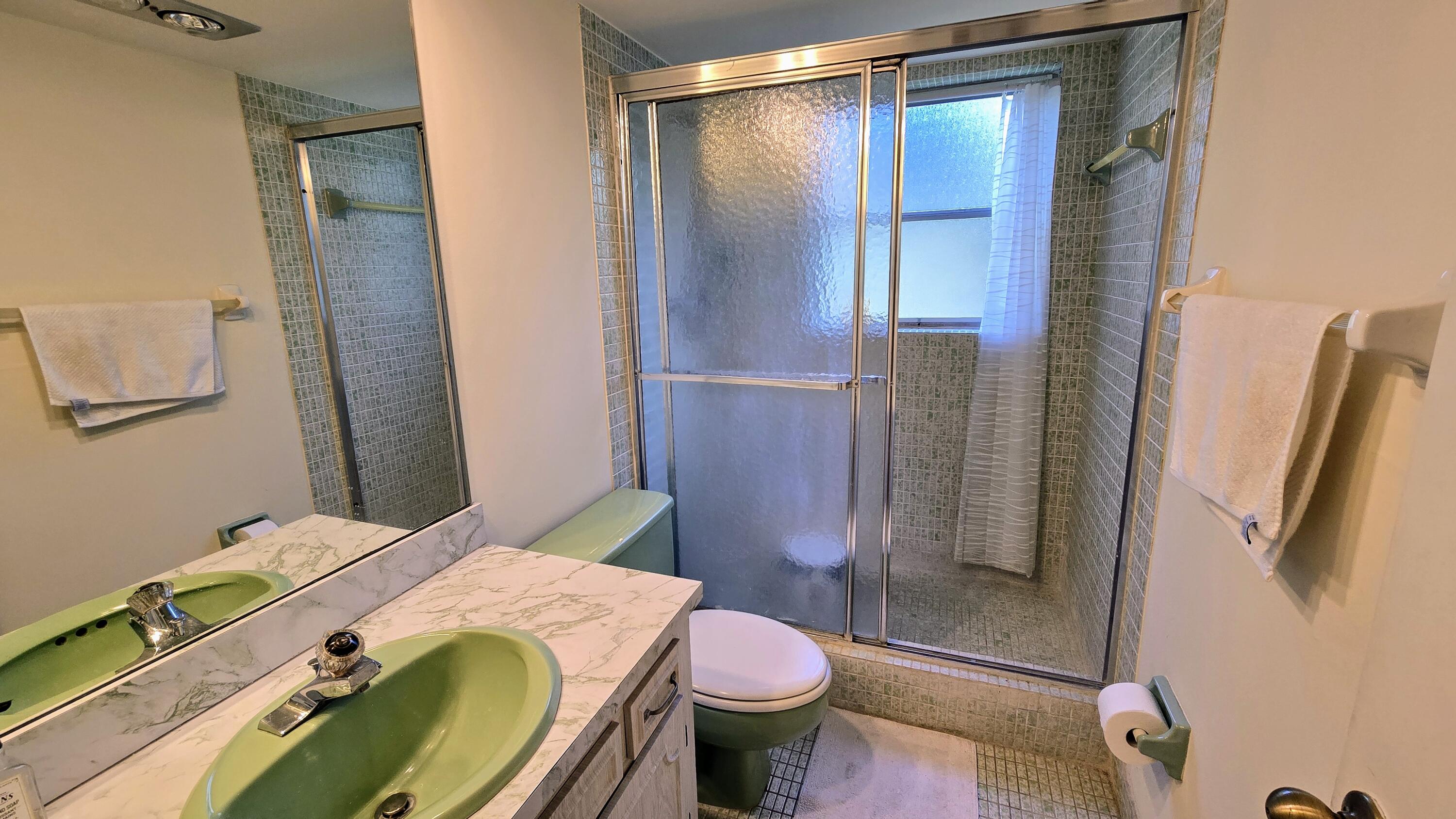 3100 North Course Lane, Unit 410 Pompano Beach, FL 33069 - Photo 19 of 23 a bathroom with a sink and toilet