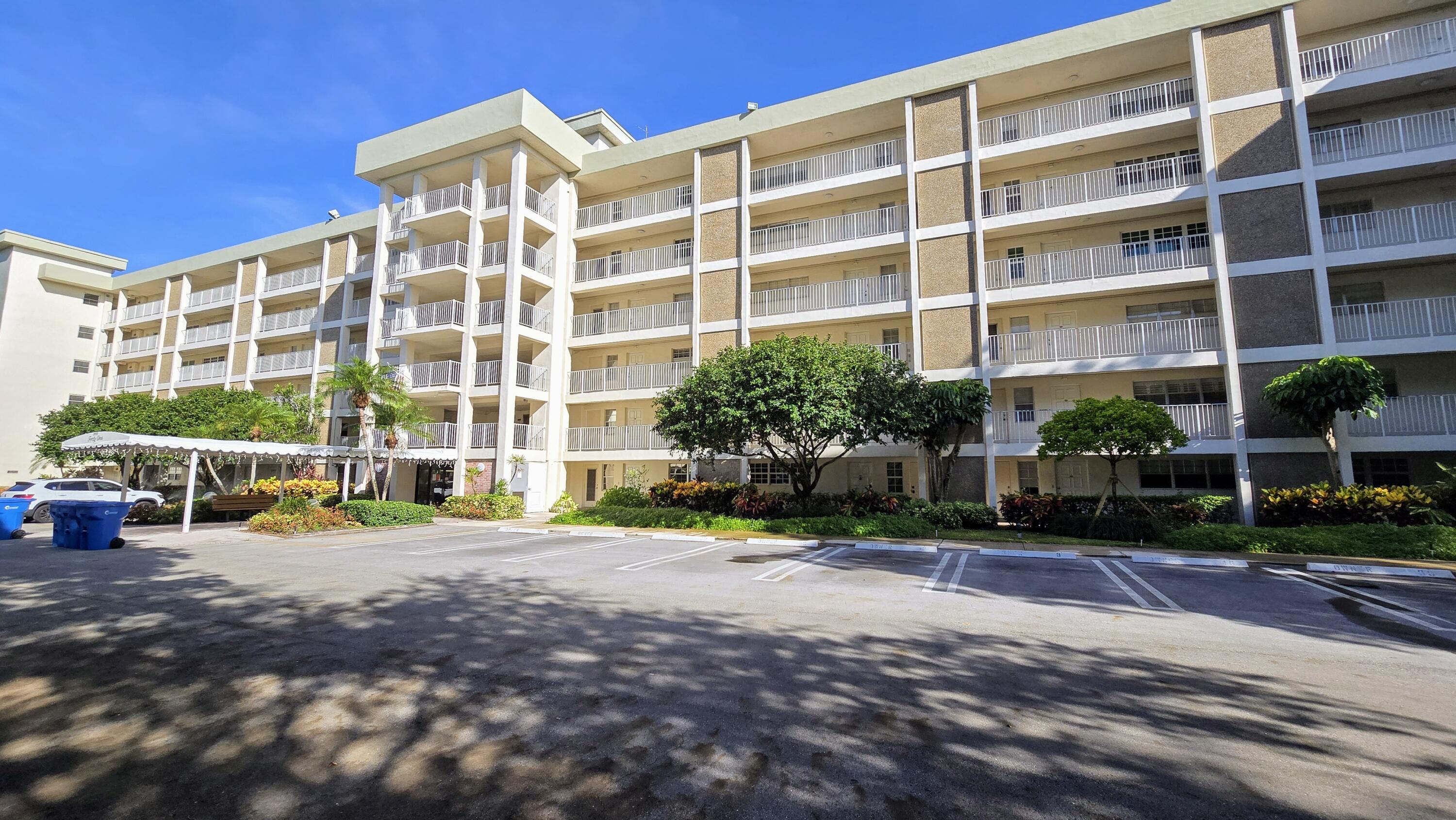 3100 North Course Lane, Unit 410 Pompano Beach, FL 33069 - Photo 20 of 23 a view of a building with a garden and pathway
