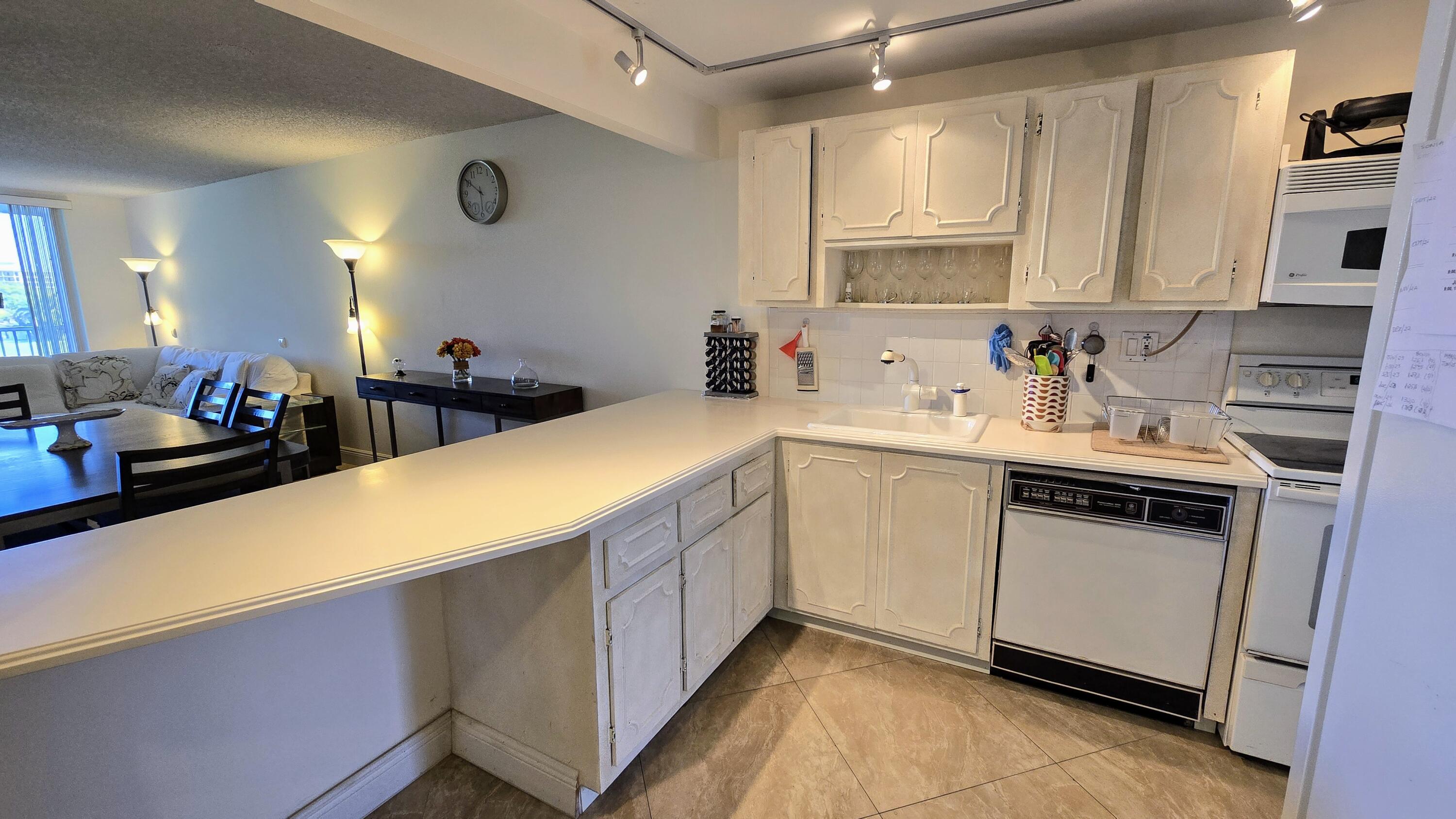 3100 North Course Lane, Unit 410 Pompano Beach, FL 33069 - Photo 2 of 23 a kitchen with a sink cabinets and window