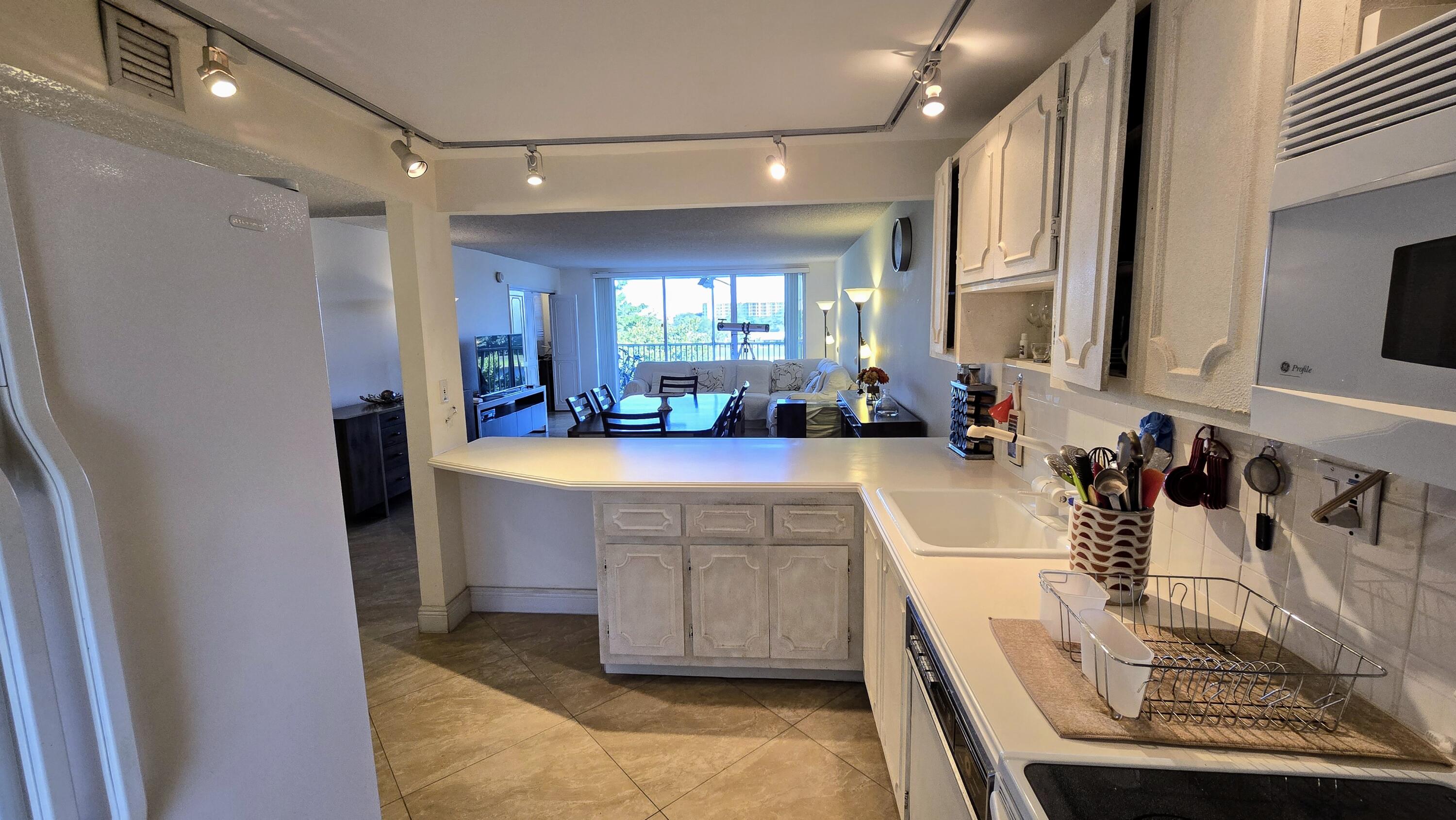 3100 North Course Lane, Unit 410 Pompano Beach, FL 33069 - Photo 3 of 23 a large bathroom with a double vanity sink a mirror and a bathtub