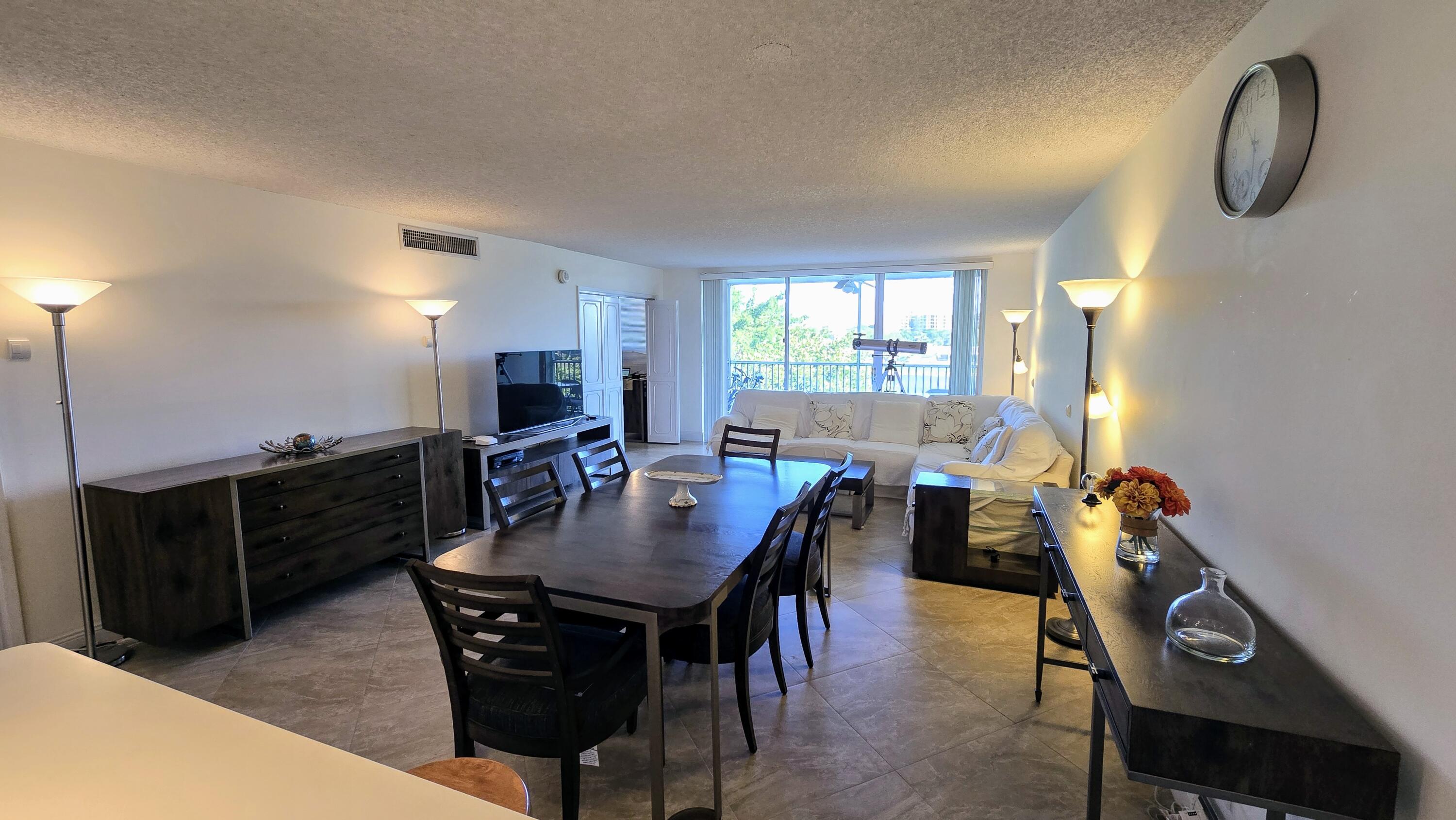 3100 North Course Lane, Unit 410 Pompano Beach, FL 33069 - Photo 4 of 23 a view of a dining room with furniture and window