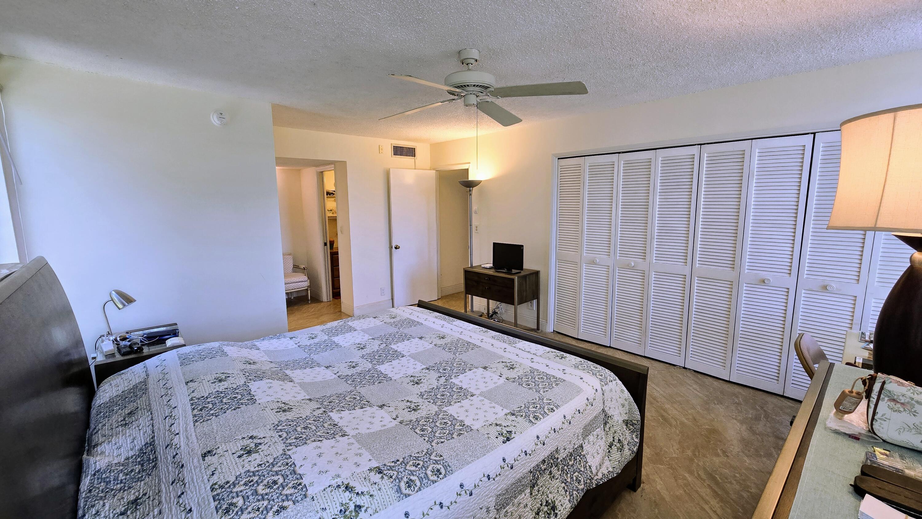 3100 North Course Lane, Unit 410 Pompano Beach, FL 33069 - Photo 5 of 23 a bedroom with a bed a dresser and a window