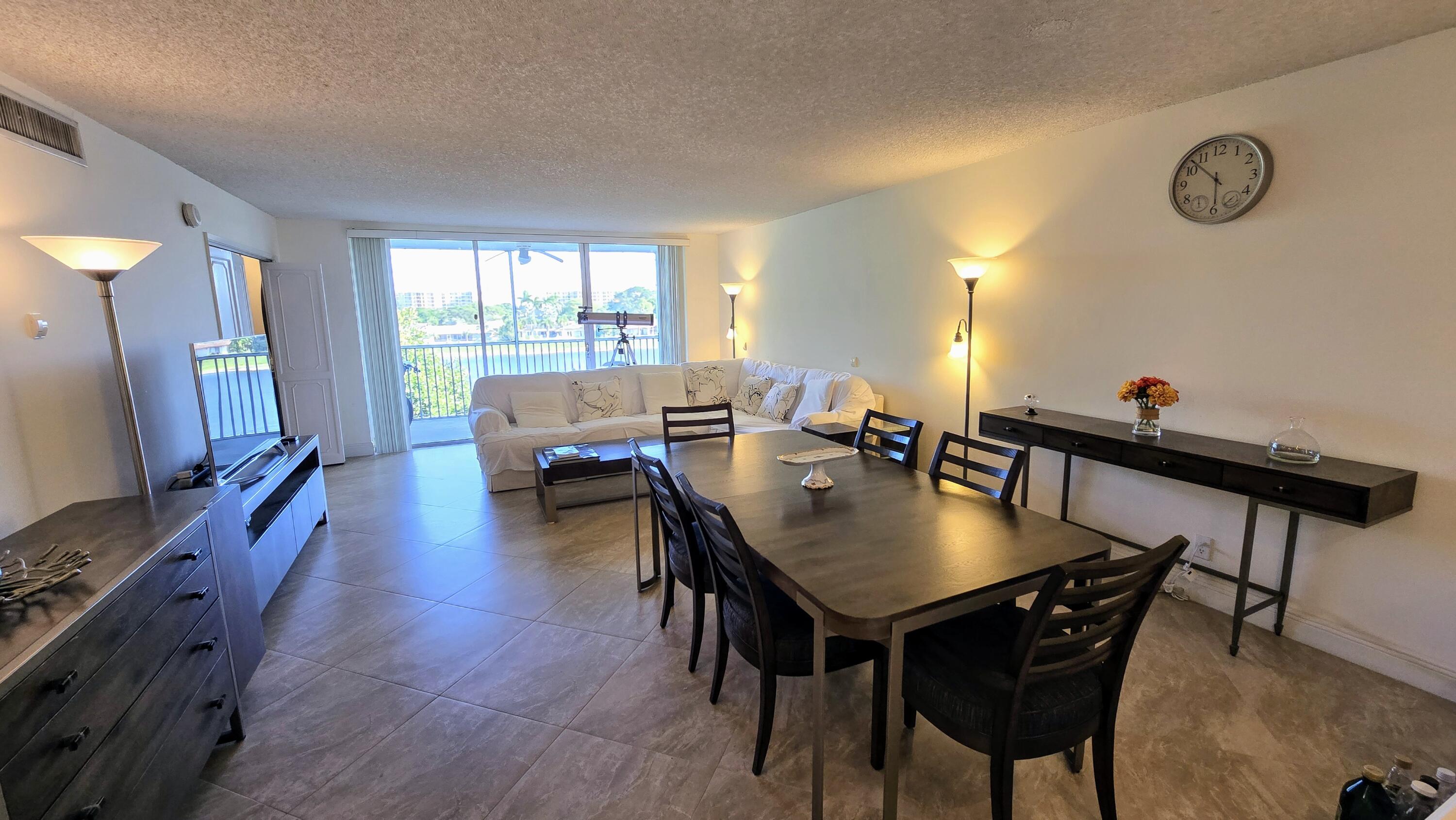 3100 North Course Lane, Unit 410 Pompano Beach, FL 33069 - Photo 6 of 23 a view of a dining room with furniture and wooden floor
