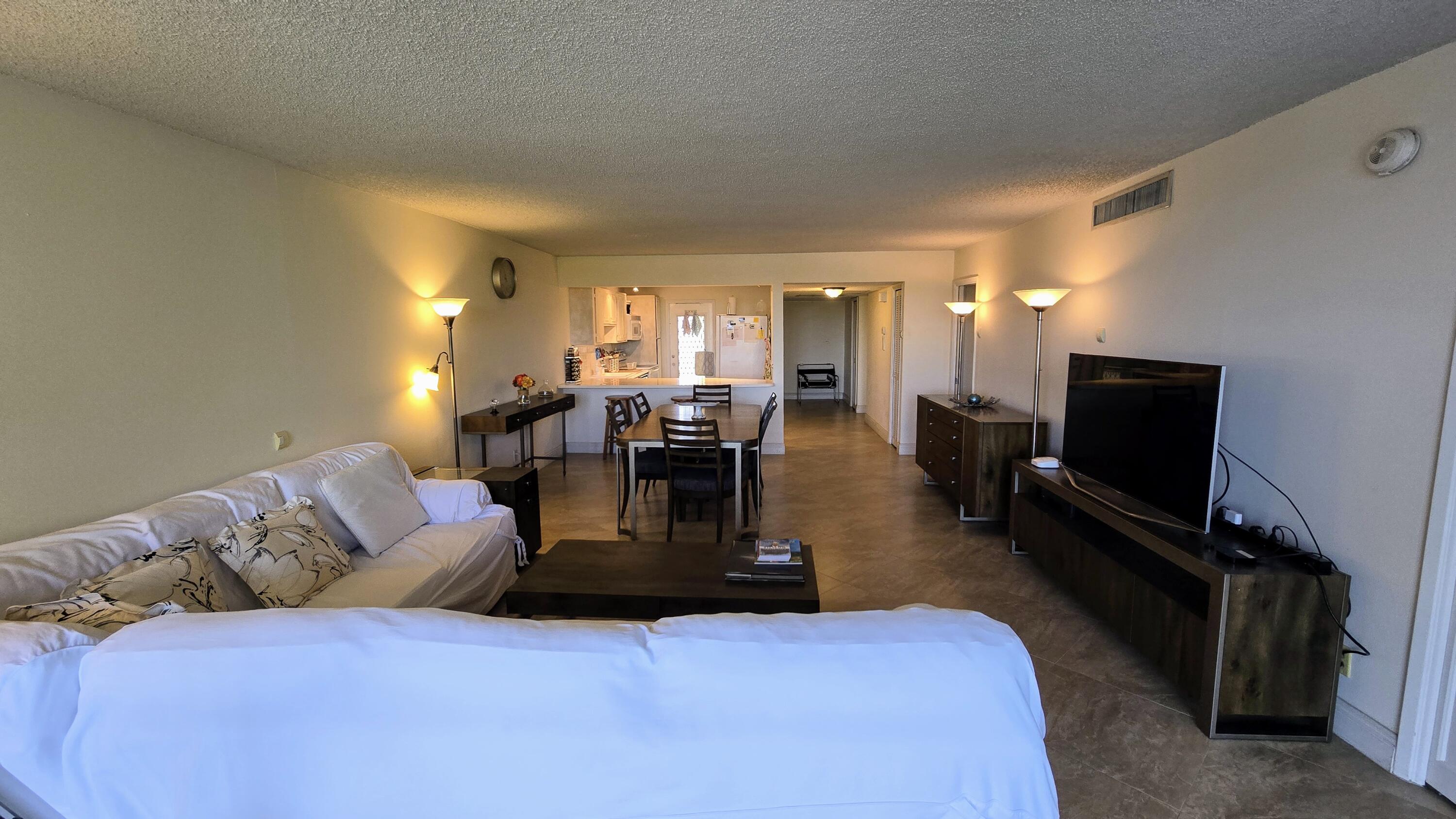 3100 North Course Lane, Unit 410 Pompano Beach, FL 33069 - Photo 9 of 23 a living room with furniture and a flat screen tv