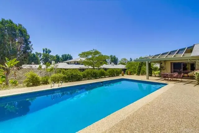 a view of swimming pool with outdoor seating and plants