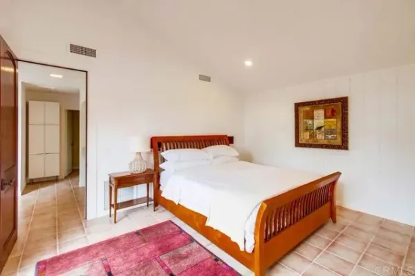 a bed room with a bed and a painting