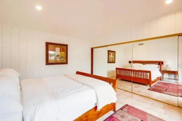 a bedroom with a bed and dresser