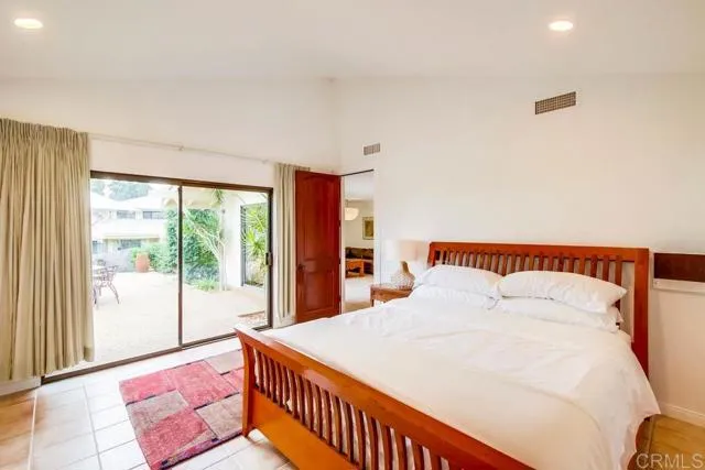 17355 Avenida De Acacias Rancho Santa Fe, CA 92067 - Photo 7 of 16 a bedroom with a large bed and a large window