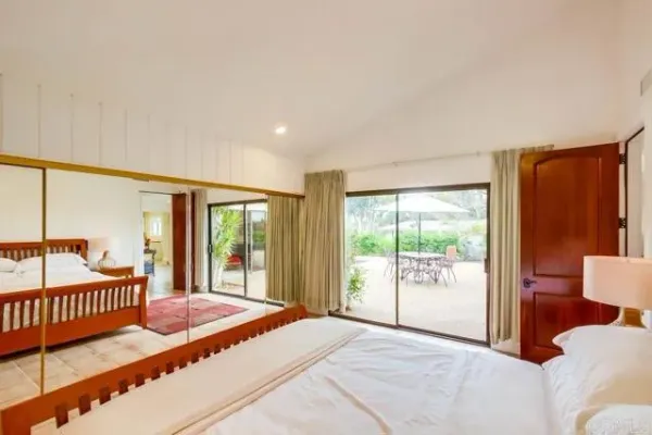 a bedroom with a bed and glass window