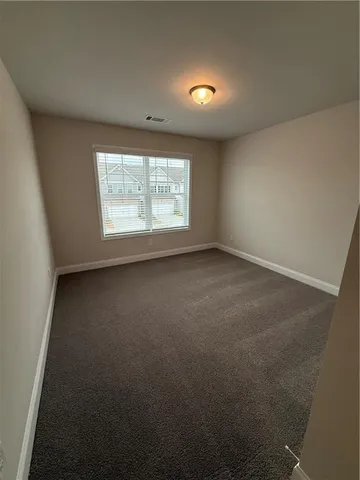 a bathroom with a granite countertop sink mirror vanity and toilet