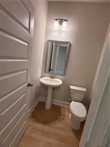 a white toilet sitting next to a bathroom sink