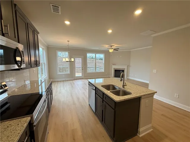 a kitchen with a sink stove and cabinets