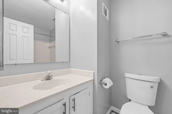 a bathroom with a sink toilet and a mirror