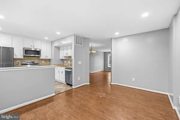a kitchen with granite countertop a stove sink and refrigerator