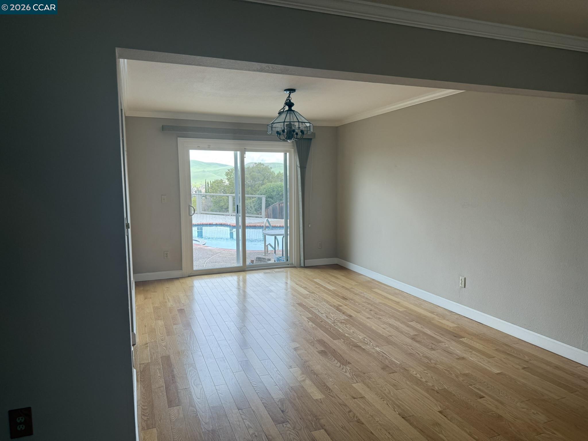 1109 Vista Point Lane Concord, CA 94521 - Photo 11 of 26 an empty room with wooden floor chandelier and windows