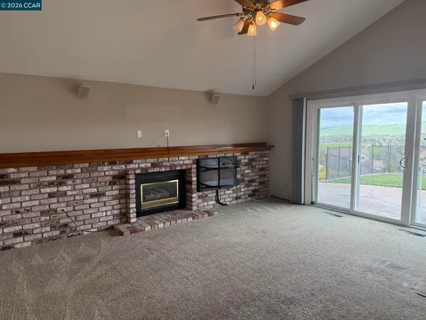 a view of an empty room with a fireplace