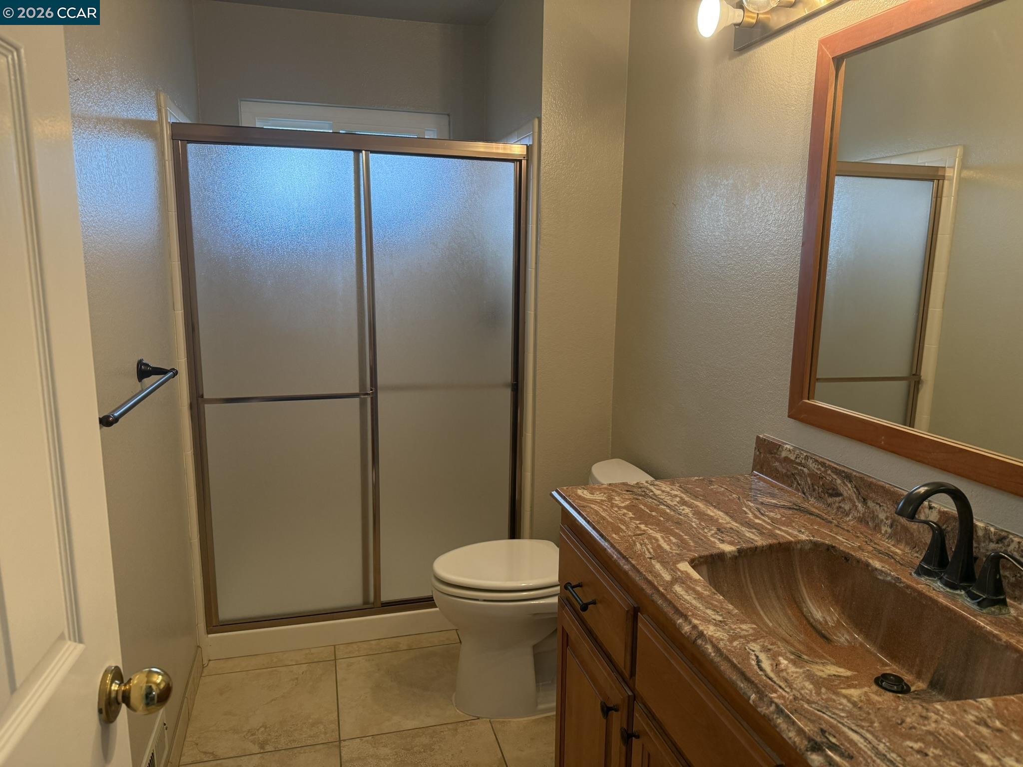 1109 Vista Point Lane Concord, CA 94521 - Photo 16 of 26 a bathroom with a granite countertop sink toilet and shower