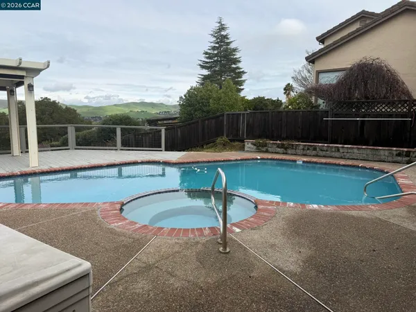 a swimming pool with wooden fence