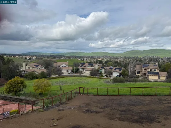a view of a field with ocean view