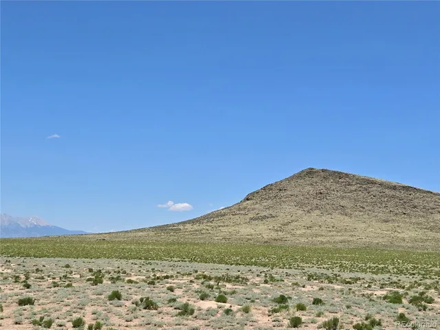 a view of a field with an ocean