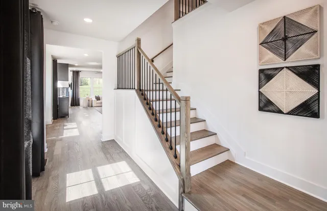 a view of entryway and hall with wooden floor
