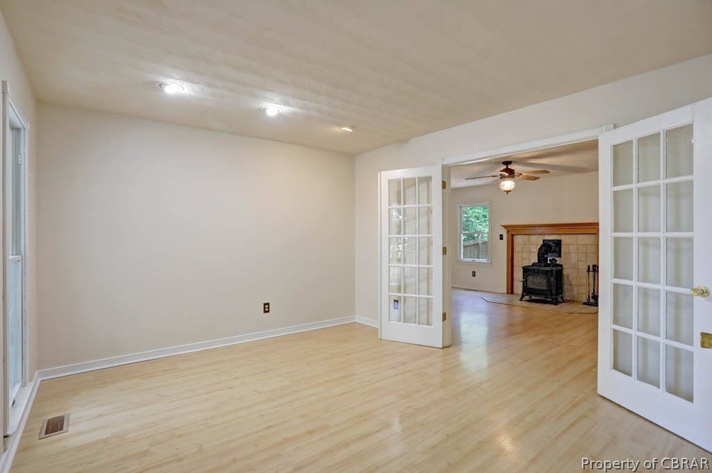 7025 Mumford Cove Road Hayes, VA 23072 - Photo 6 of 43 Living room/flex space to the left of entryway with French doors.