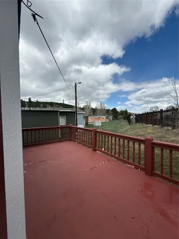 a view of balcony with wooden floor and fence