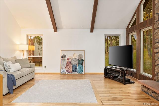 a living room with furniture and a floor to ceiling window