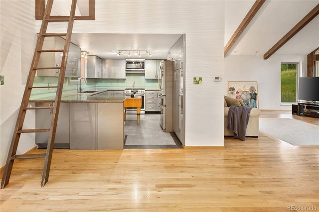 a kitchen with granite countertop cabinets and steel stainless steel appliances