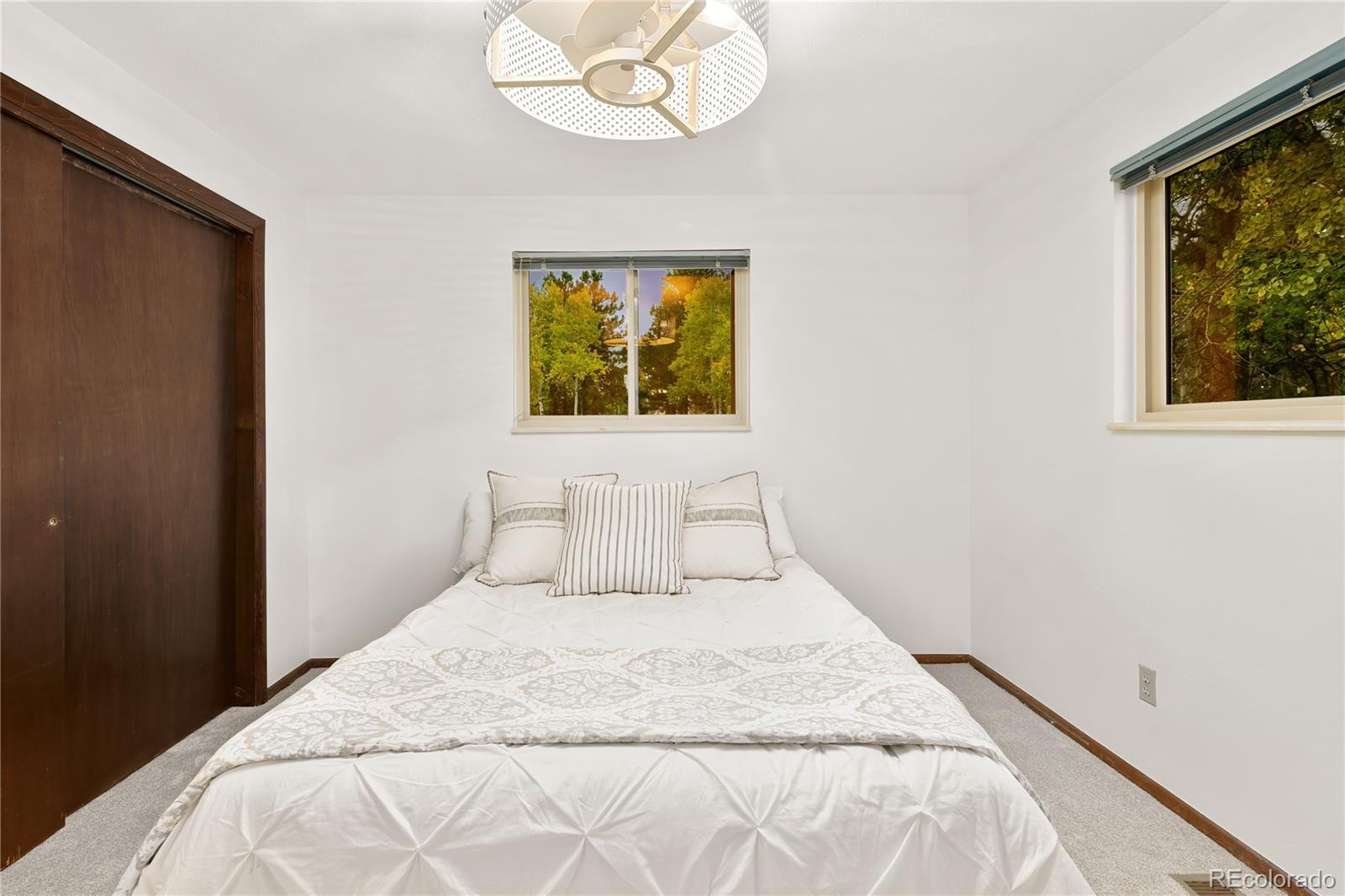 28696 Little Big Horn Drive Evergreen, CO 80439 - Photo 24 of 47 a bedroom with a bed and a window