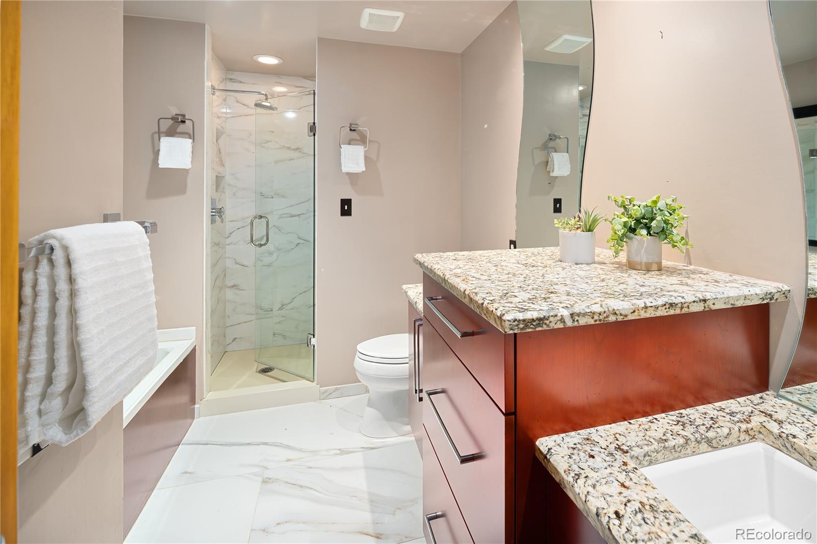 28696 Little Big Horn Drive Evergreen, CO 80439 - Photo 26 of 47 a bathroom with a sink a toilet and shower