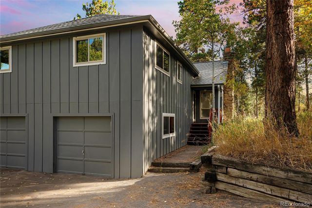 a backyard of a house with yard table and chairs