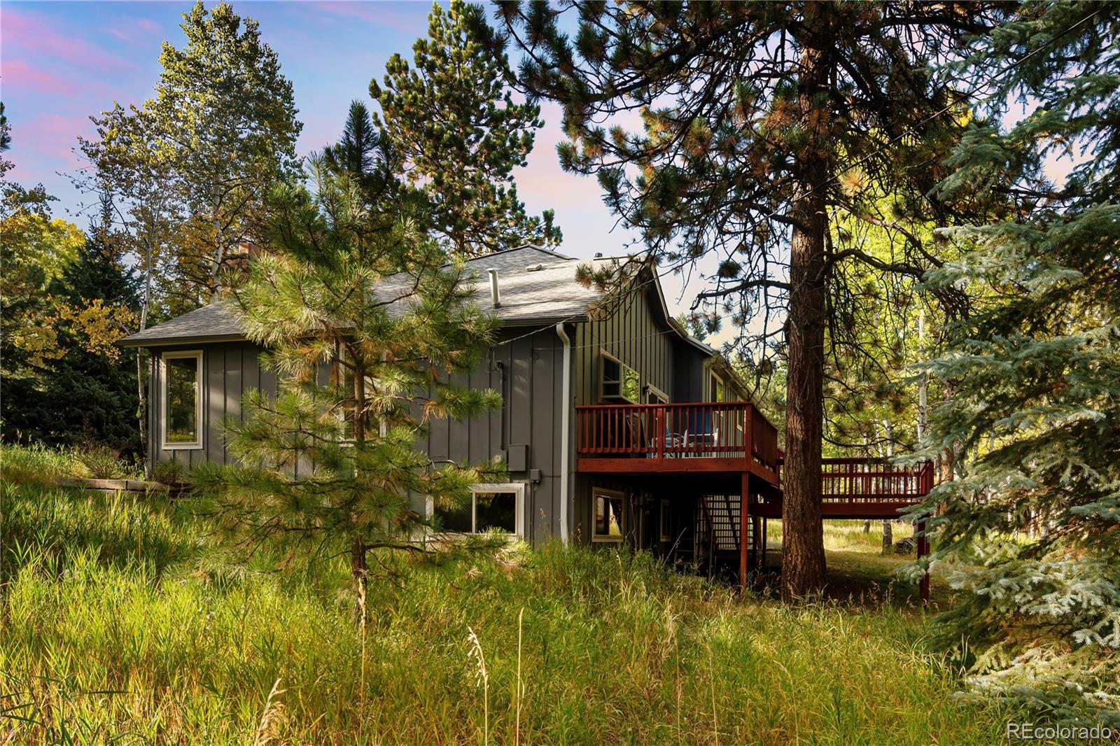 28696 Little Big Horn Drive Evergreen, CO 80439 - Photo 4 of 47 a front view of a house with a garden