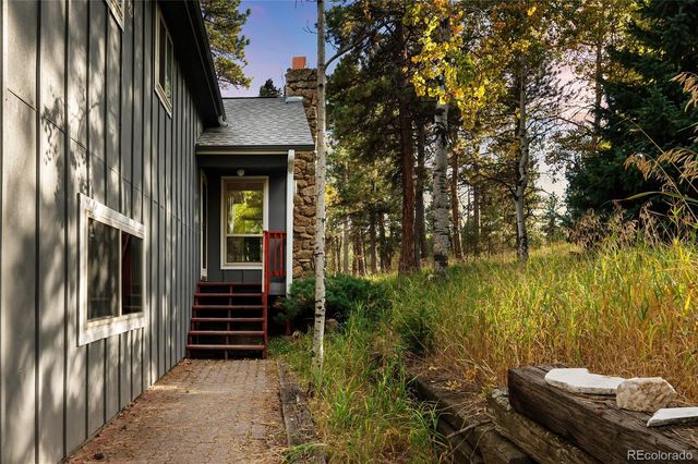 a view of an entryway with wooden floor and a livingroom view