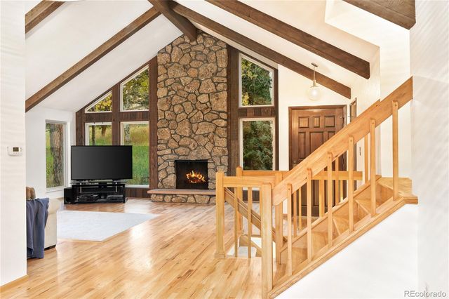 a living room with fireplace furniture and a flat screen tv
