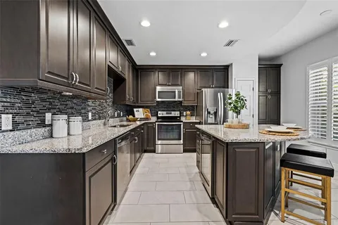 a kitchen with granite countertop a sink and a stove