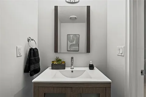 a bathroom with a toilet a sink and mirror