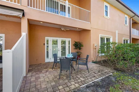 a backyard of a house with table and chairs