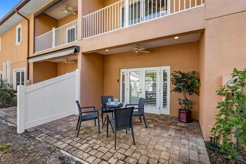 a view of a house with backyard sitting area and swimming pool