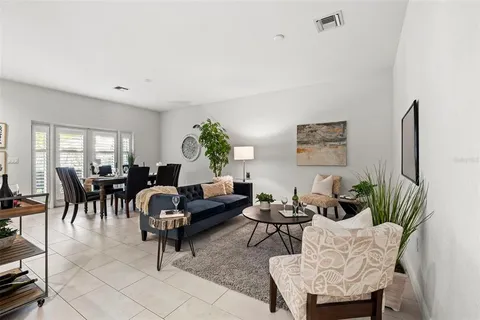 a kitchen with stainless steel appliances granite countertop a stove a sink a microwave a dining table and chairs