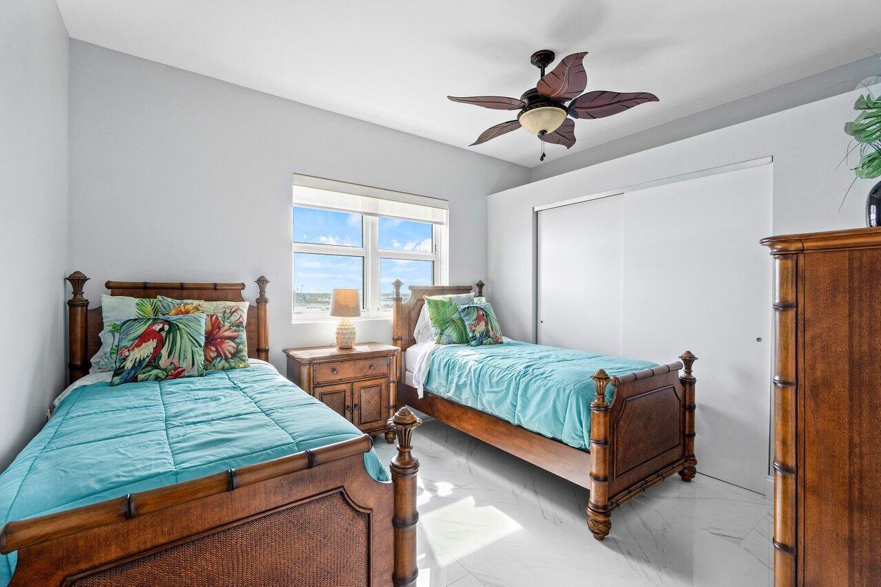 2640 Lake Shore Drive, Unit 1216 Riviera Beach, FL 33404 - Photo 17 of 60 a bedroom with a bed and window